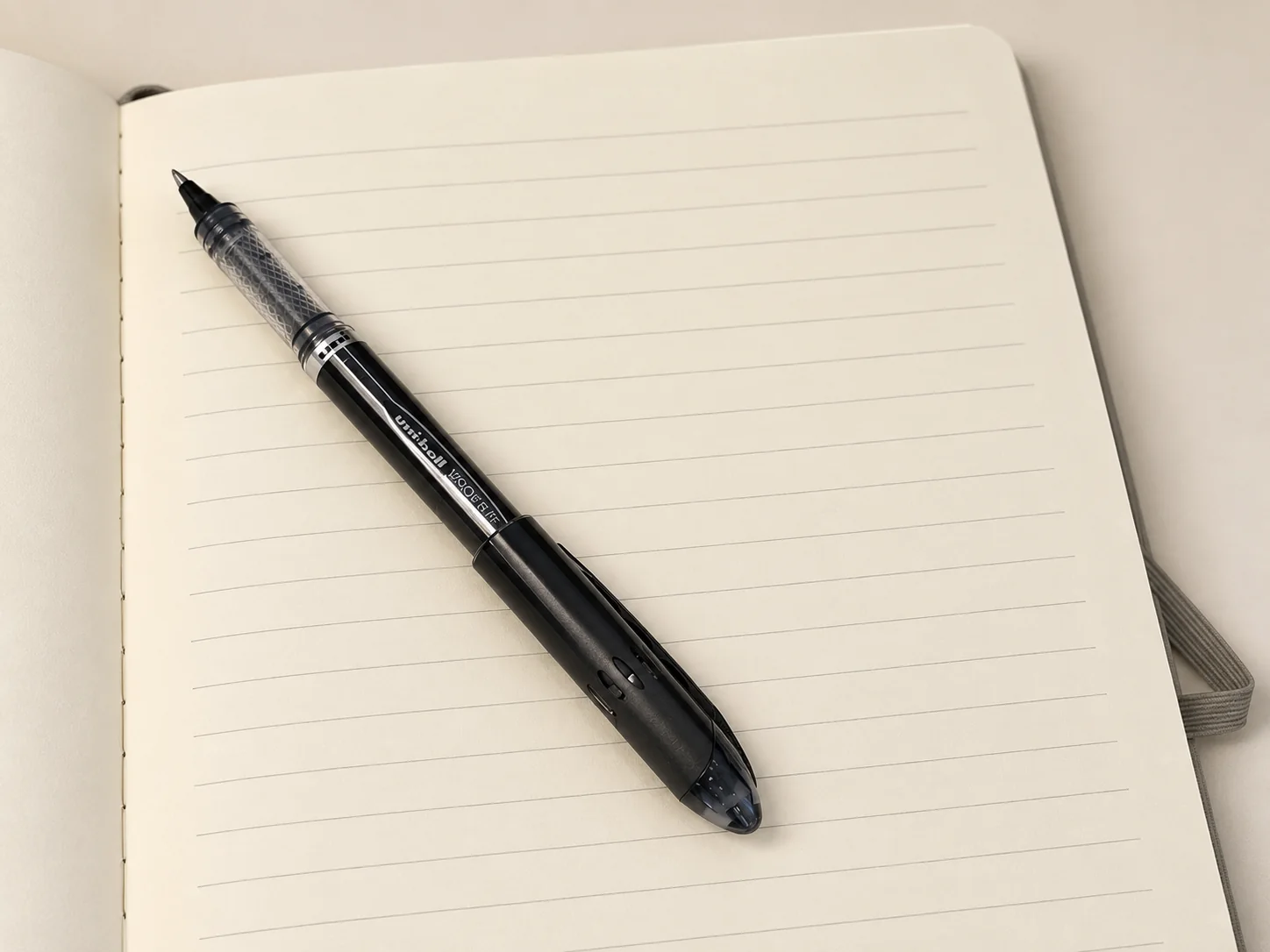 A real Gospelis journal opened with a pen resting across its heavyweight ruled pages